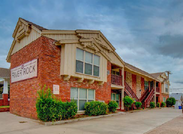 A building with a sign that says River Rock.