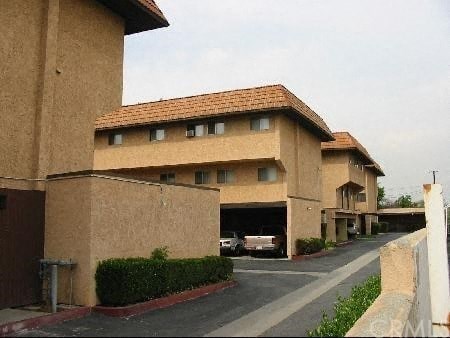 A building with a brown facade and a red roof.