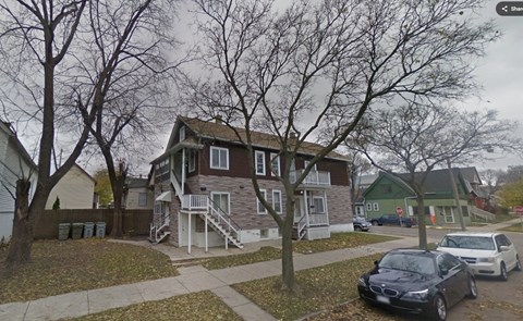A house with a car parked in front.