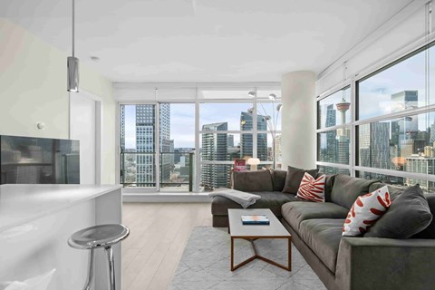 A modern living room with a large window overlooking the city.