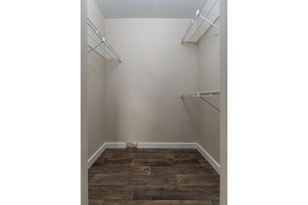 A room with wood flooring and white walls.