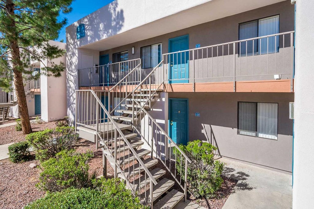A building with a staircase leading to a balcony.