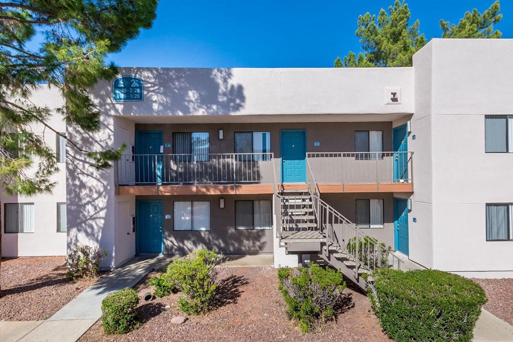 A modern apartment building with blue doors and windows.