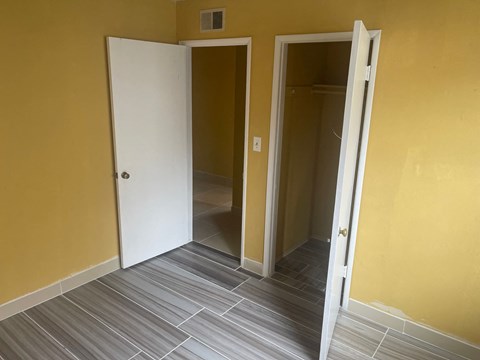 Two white doors open to empty rooms.