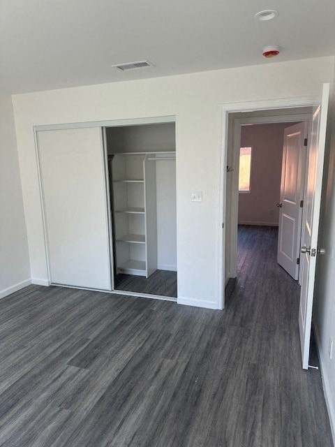 A room with a grey floor and a white door.