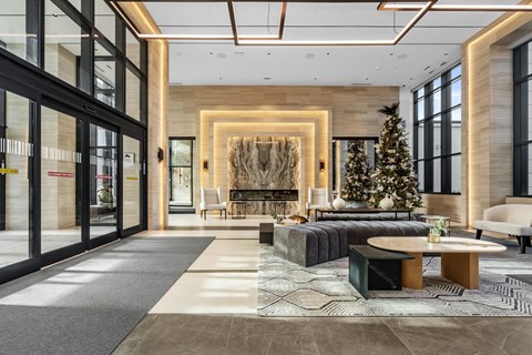 A modern living room with a Christmas tree and a fireplace.