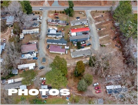 An aerial view of a parking lot with cars and buildings.