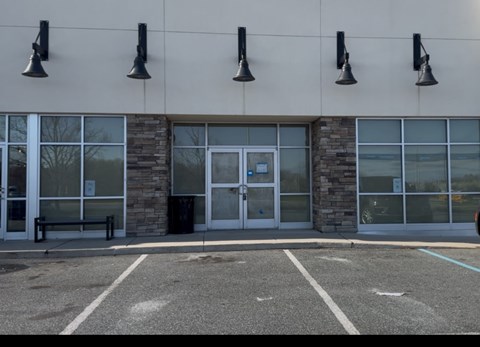 A building with a stone pillar and a glass door.