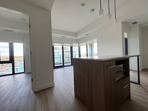 A modern kitchen with wooden cabinets and a large island.