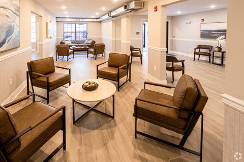 A living room with brown leather chairs and a coffee table.