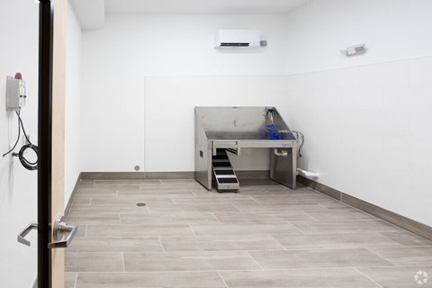 A kitchen area with a stainless steel counter and a sink.