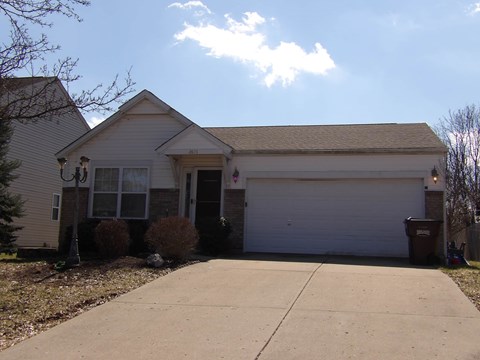 A house with a white garage door and a driveway.