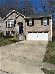A brick house with a black door and a white garage door.