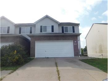 A house with a white garage door in front.
