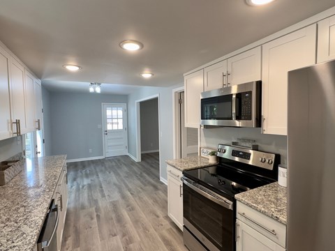 A kitchen with a stove top oven and microwave.