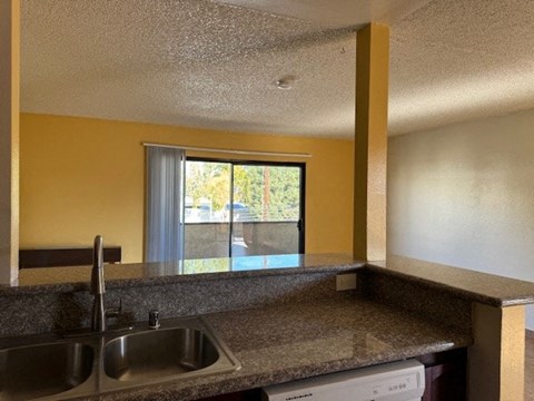 A kitchen with a sink and a window.