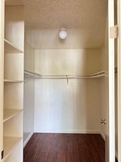 A white hallway with a light on the ceiling.