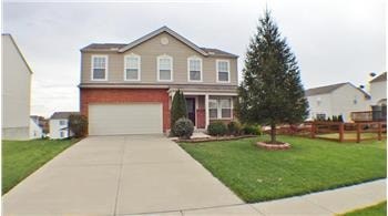 A two-story house with a garage and a driveway.