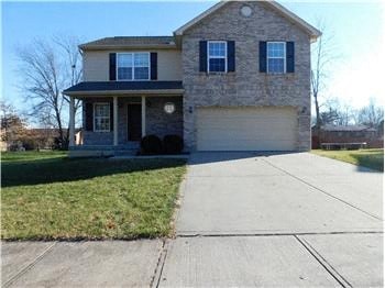 A two-story house with a garage and a driveway.