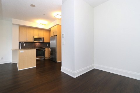 A kitchen with wooden cabinets and a black counter top.