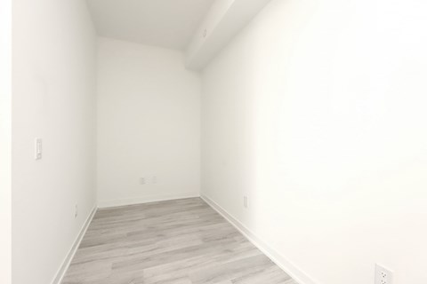 A room with white walls and wooden flooring.