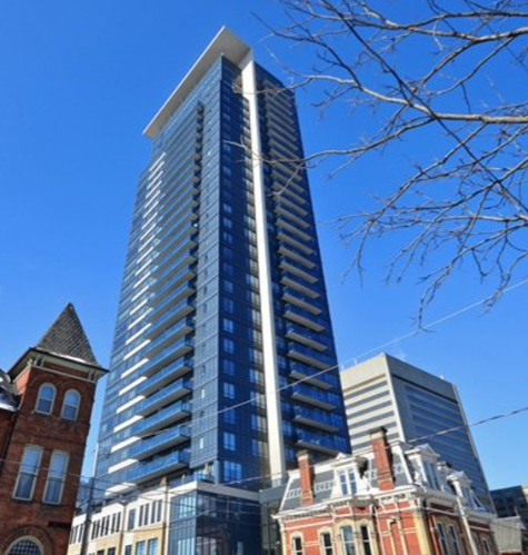 A tall blue and white building stands next to a shorter red brick building.