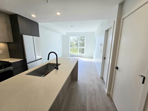 A modern kitchen with a sink and a window.