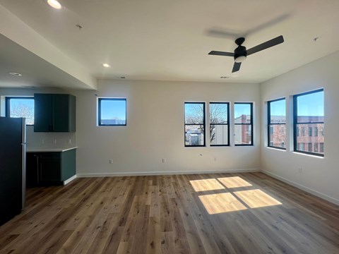 A room with wooden floors and a ceiling fan.