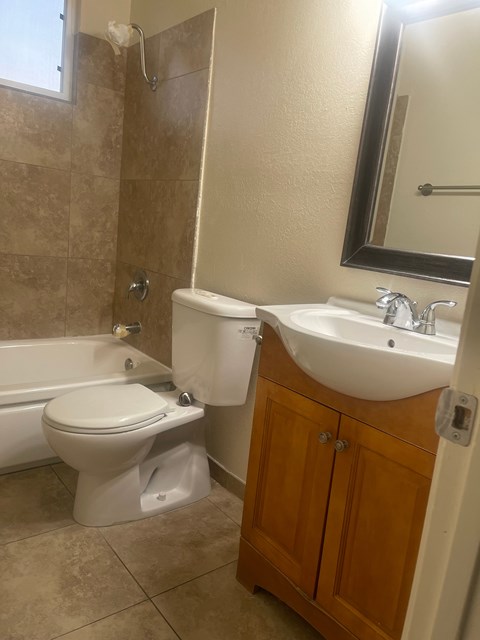 A white toilet sits next to a sink in a bathroom.