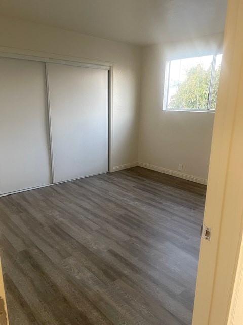 A room with a sliding door and a window.