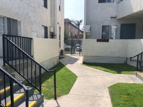 A concrete staircase with yellow stripes leads to a building.