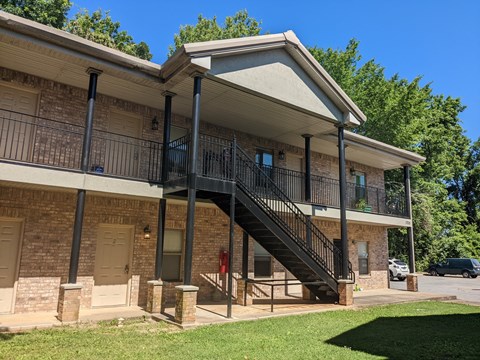 A house with a black metal staircase leading to the second floor.