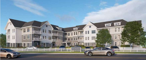 A modern residential building with multiple floors and a parking lot in front.
