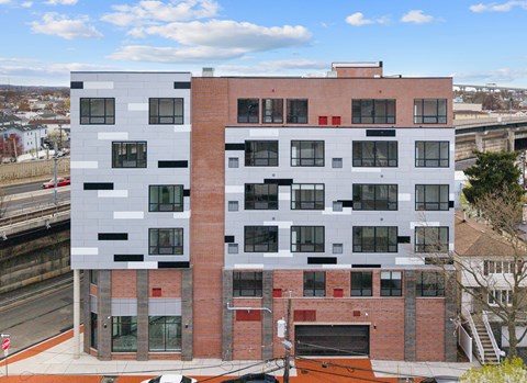 A modern building with a combination of white and red brick and black accents.