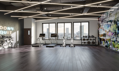 A gym with a large window overlooking a city skyline.