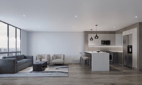 A modern living room with a grey sofa, two chairs, a coffee table, and a kitchen area in the background.