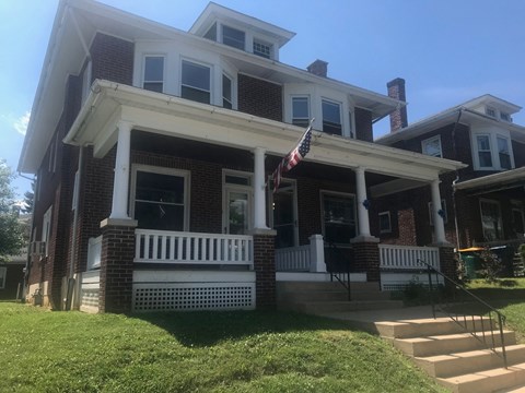 A house with a flag on the porch.