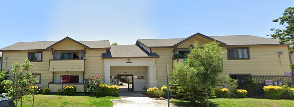 A two-story house with a garage and a driveway.