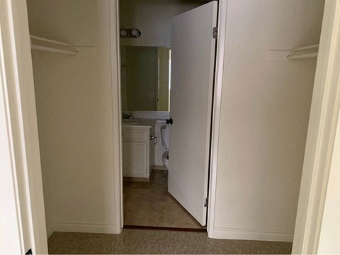 A white door is open to a bathroom.