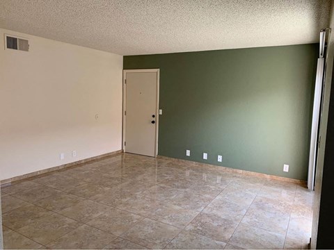 A room with a door and tiled floor.