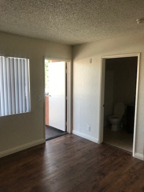 A room with a toilet in the open doorway.