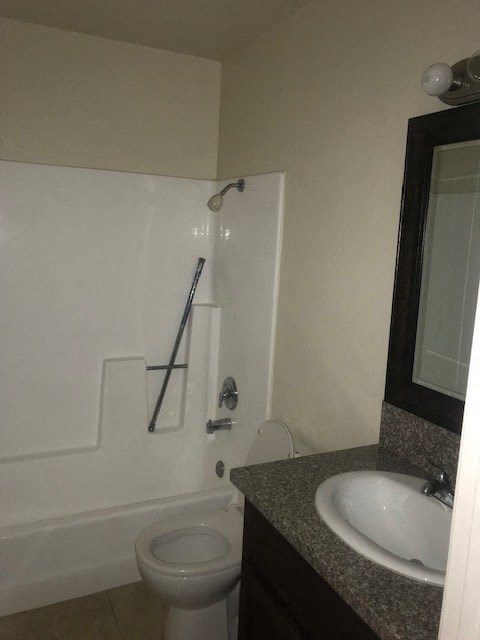 A white toilet sits next to a sink in a bathroom.