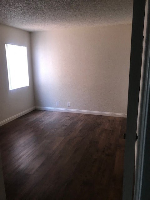A room with a window and wooden floors.