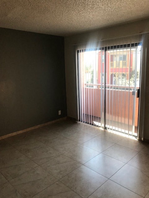 A room with a sliding glass door leading to a balcony.