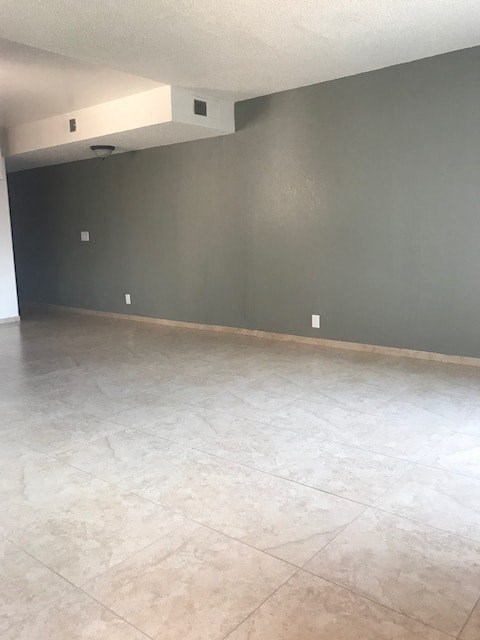 A room with a tiled floor and grey walls.