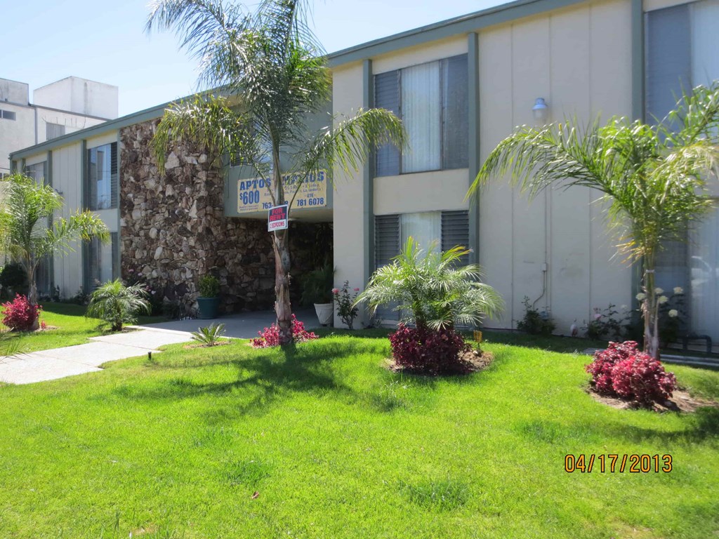 A building with a sign that says "APTON 105" in front of it.