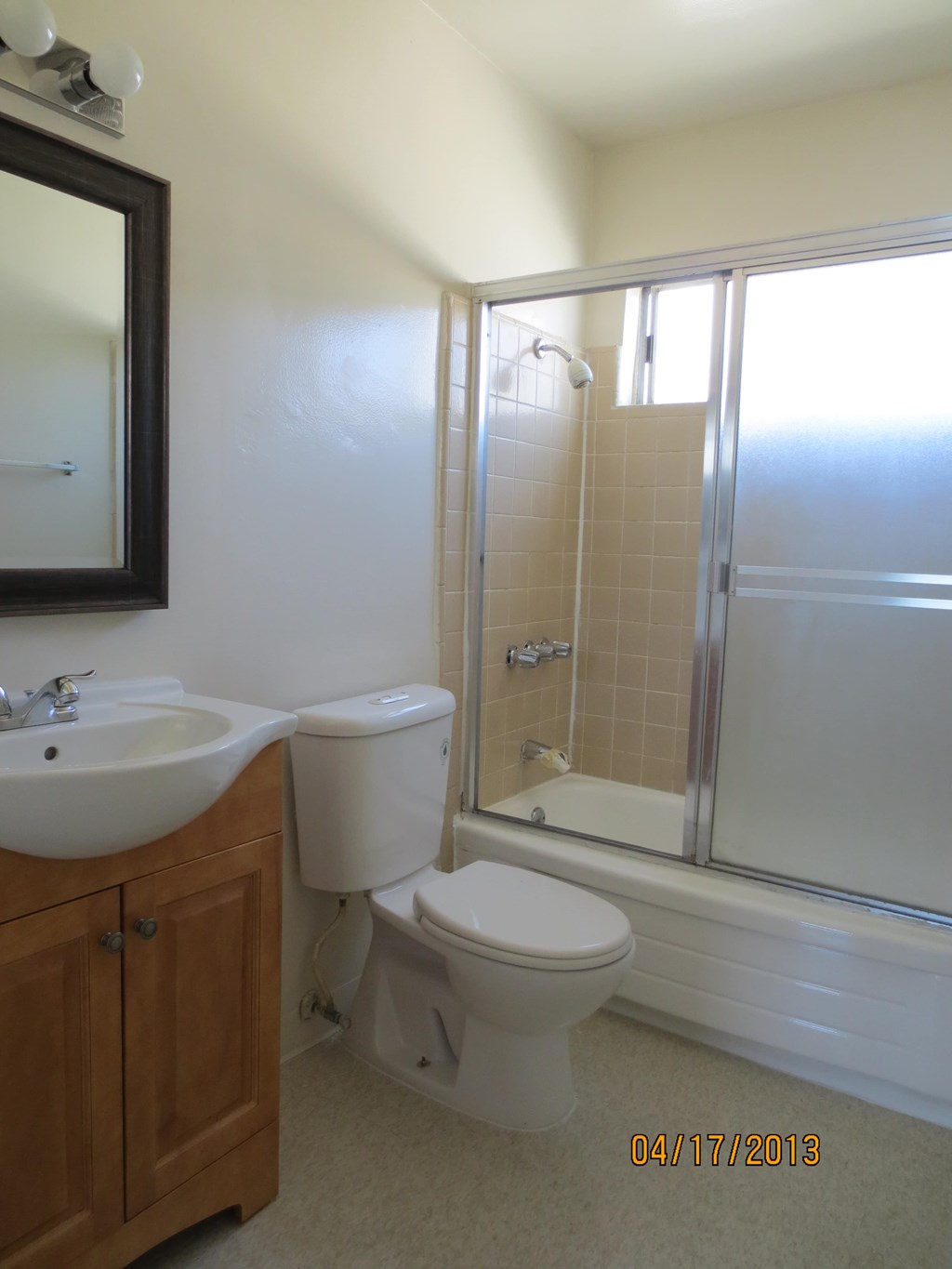 A bathroom with a toilet, sink, and shower.