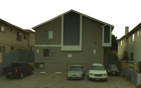 A building with a parking lot in front of it.