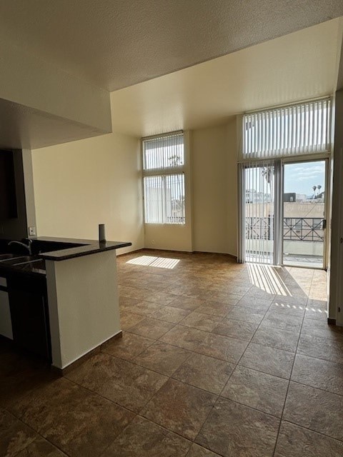 A kitchen with a black counter top and white cabinets.