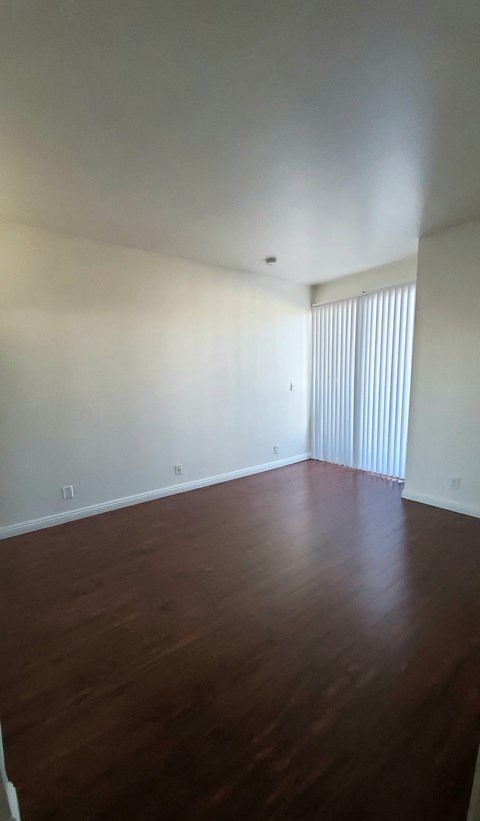 A room with wooden floors and white walls.
